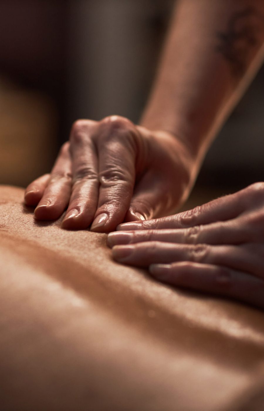 Masseuse using petrissage technique when massaging back of client